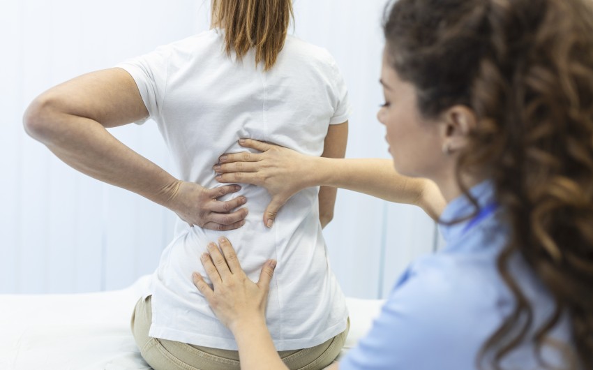 physiotherapist-doing-healing-treatment-on-womans-back-back-pain-patient-treatment-medical-doctor-massage-therapistoffice-syndrome.jpg